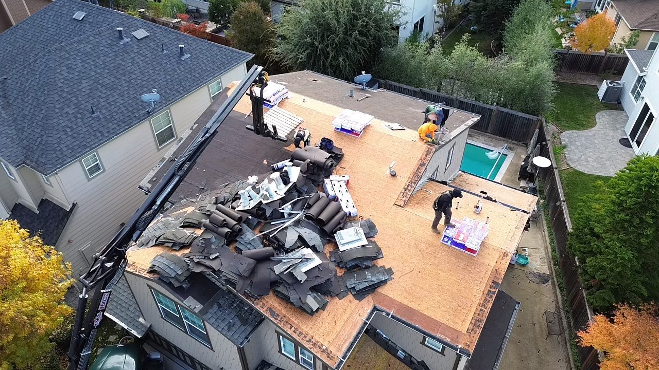 Roofer working safely on a residential roof